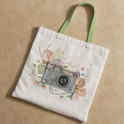 A tote bag adorned with a graphic of a camera, showcasing a stylish accessory surrounded with flowers