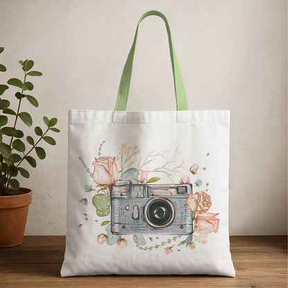 A tote bag featuring a printed image of a camera on its front side.