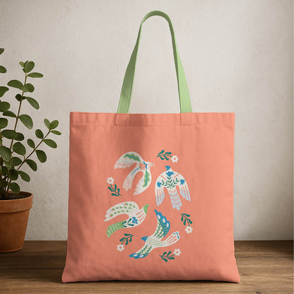 A tote bag featuring birds with vibrant, colorful design, showcasing various patterns and hues.