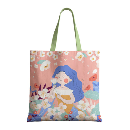 A tote bag showcasing a woman in a orange dress, complemented by a floral design.