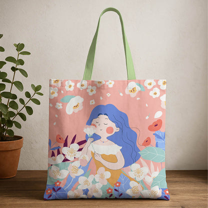 A tote bag featuring a woman in a orange dress surrounded by colorful flowers.