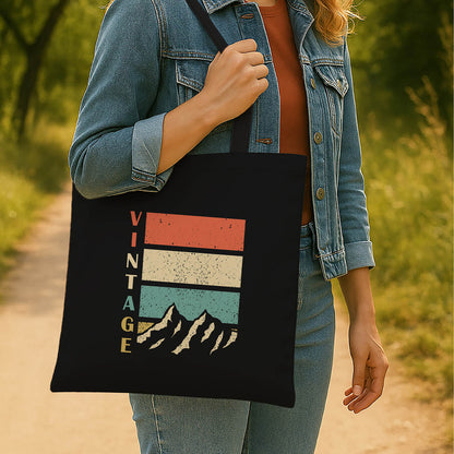A vintage tote bag showcasing a mountain scene, ideal for carrying essentials on hiking trips or casual outings.