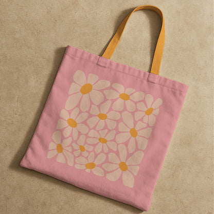 A vibrant pink tote bag with cheerful flowers and yellow handles, suitable for carrying personal items.