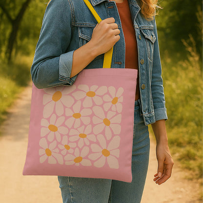 A stylish pink tote bag with contrasting flowers and yellow handles, perfect for everyday use.