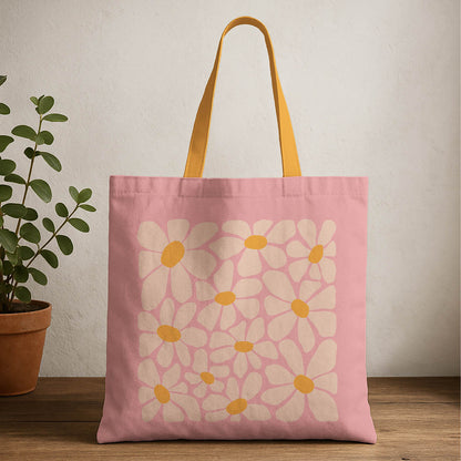A pink tote bag featuring flowers and bright yellow handles, ideal for casual outings or shopping trips.