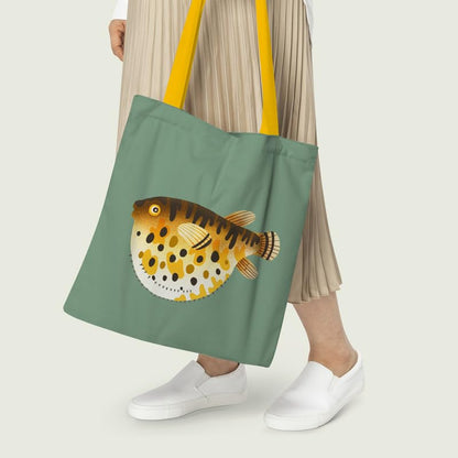A tote bag with an artistic depiction of a puffer fish against a neutral backdrop.