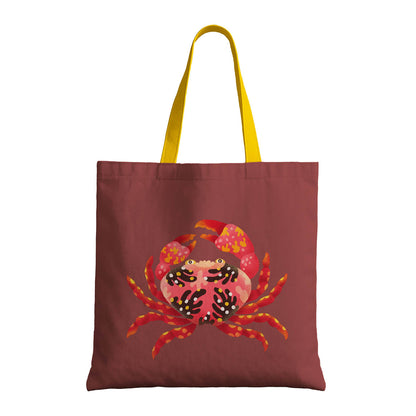 A tote bag displaying a whimsical crab motif, great for casual outings or shopping.