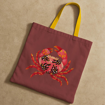 A tote bag showcasing a playful crab graphic, suitable for everyday use or beach trips.