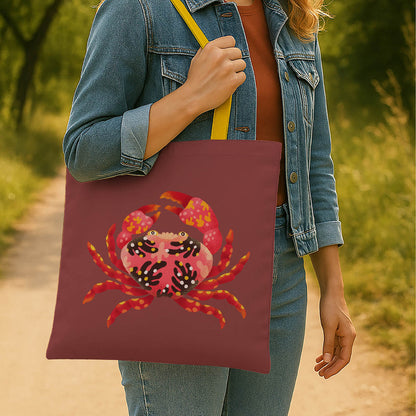 A stylish tote bag adorned with a vibrant crab illustration, ideal for carrying essentials.