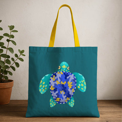 A blue and yellow tote bag featuring a turtle design prominently displayed on the front.