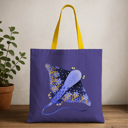 A blue and yellow tote bag featuring a stingray design prominently displayed on the front.