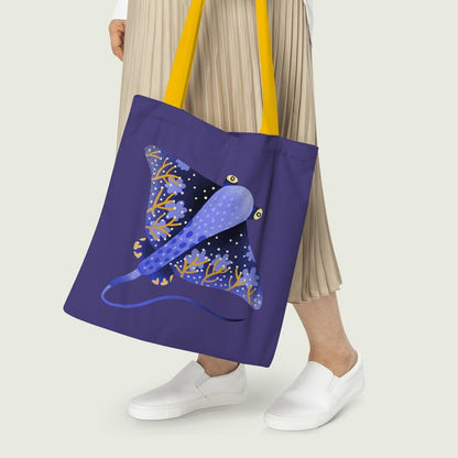 A vibrant blue and yellow tote bag with a stingray motif, ideal for beach trips or shopping.
