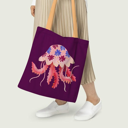 A purple tote bag with an artistic jellyfish print on its surface.