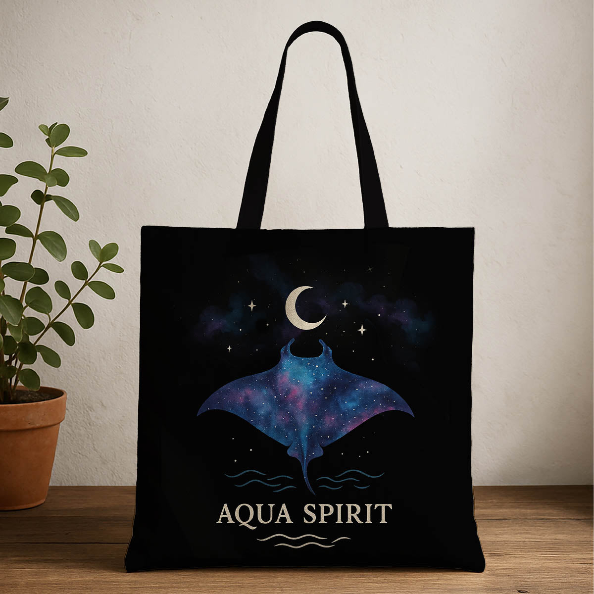 Manta ray design tote bag with moon above and aqua spirit written below featuring a vibrant design, perfect for carrying essentials with style and flair.