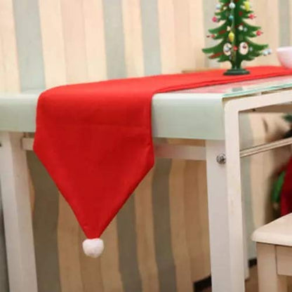 Red velvet table cover with white pom pom like santa hat