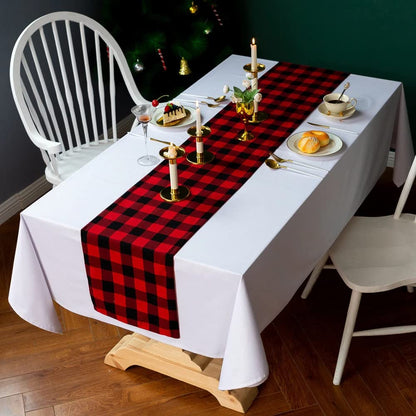 A table covered with a red and black plaid tablecloth, showcasing a classic and cozy design.
