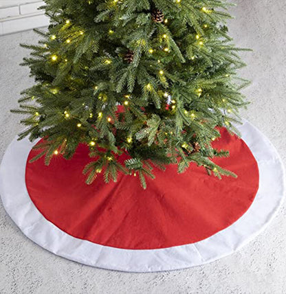 Christmas tree with a red and white tree skirt on a light gray floor.