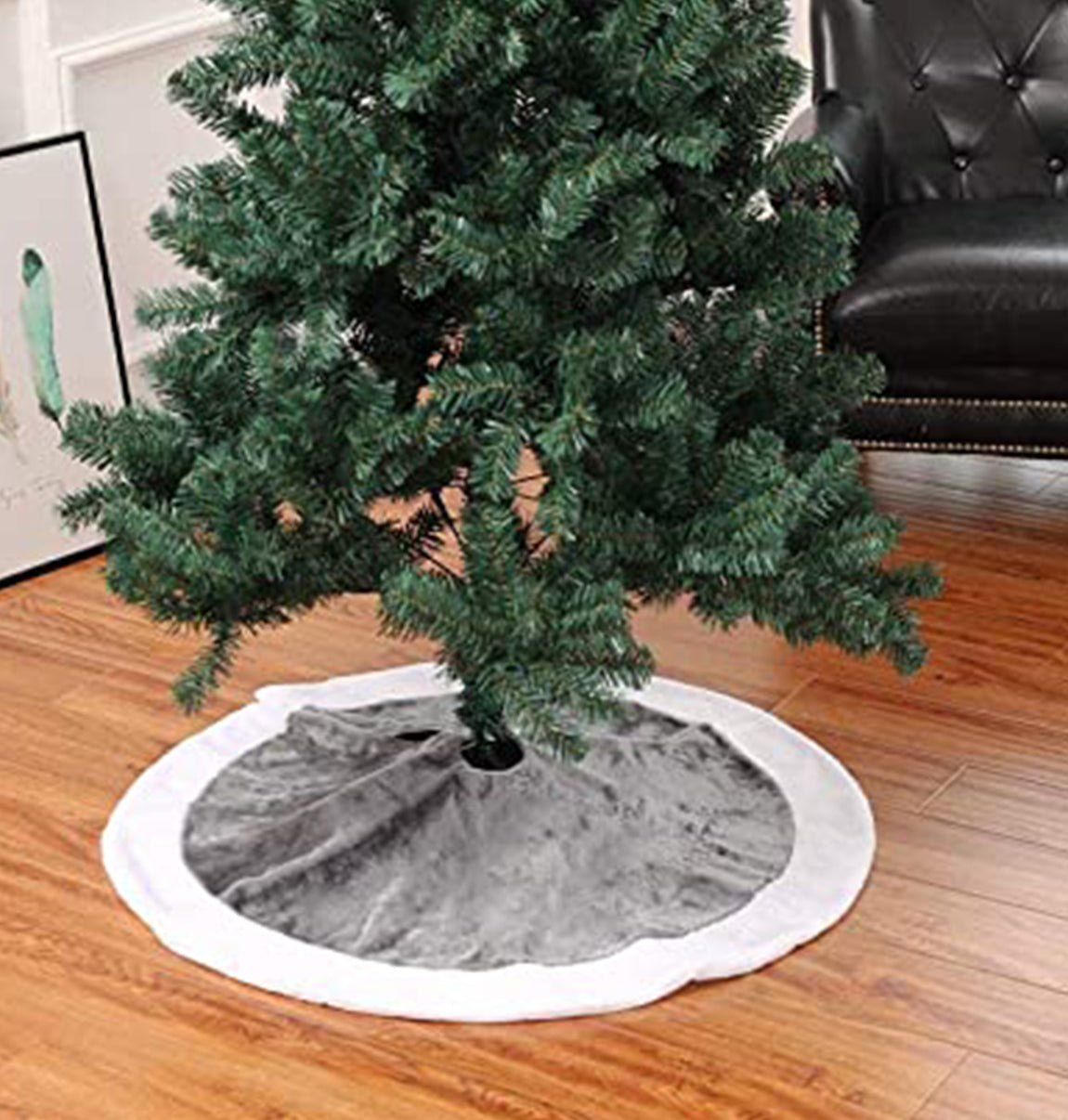 Christmas tree with a gray skirt on a wooden floor