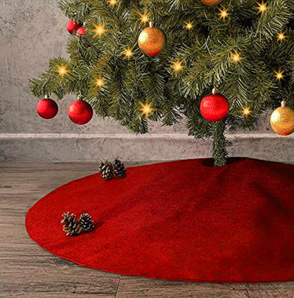 Red Christmas tree skirt with a decorated tree in the background
