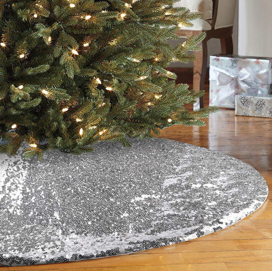 Decorative silver sequin tree skirt around a Christmas tree with lights.