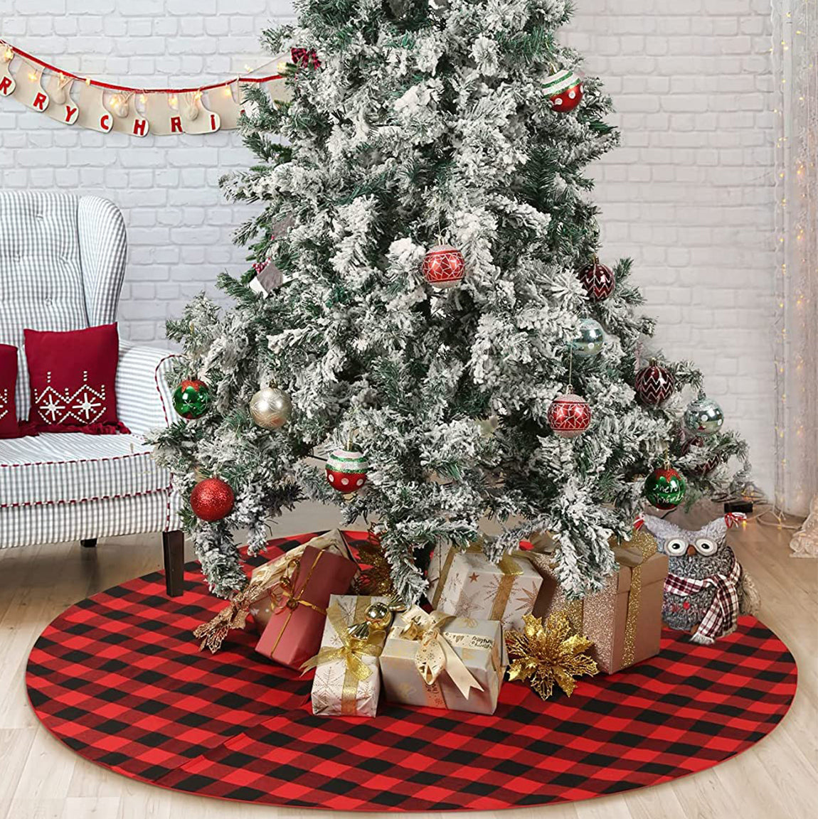 Decorated Christmas tree with ornaments and presents under a red and black checkered tree skirt.