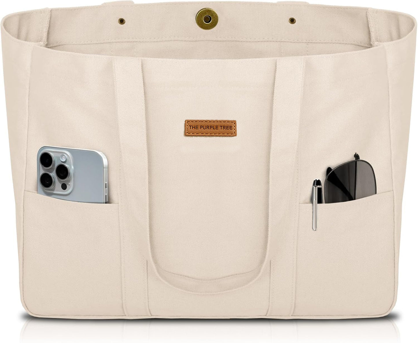 Beige tote bag with multiple pockets and a phone and sunglasses inside, branded 'The Purple Tree'.