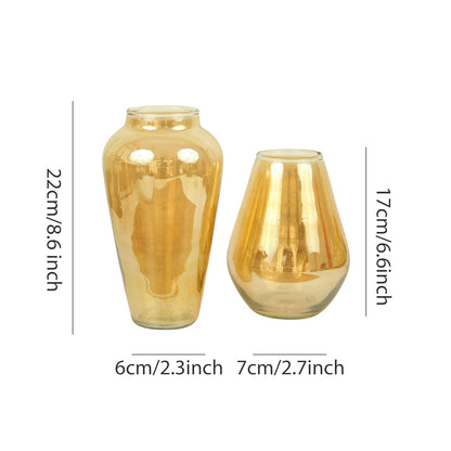 A duo of luxurious gold vases positioned closely.