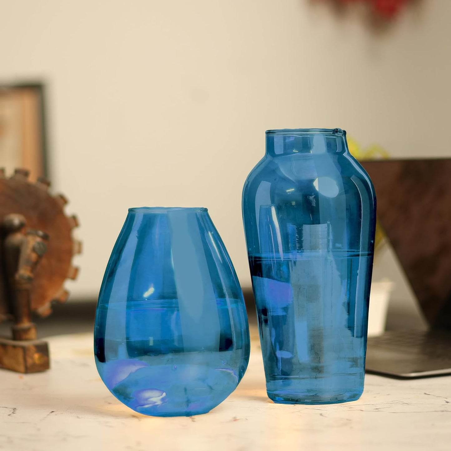 Beautiful blue vase resting on wooden table.