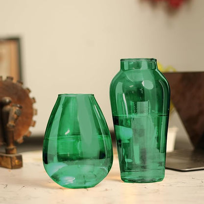 Two green glass vases on a table, adding a touch of elegance to the room's decor.