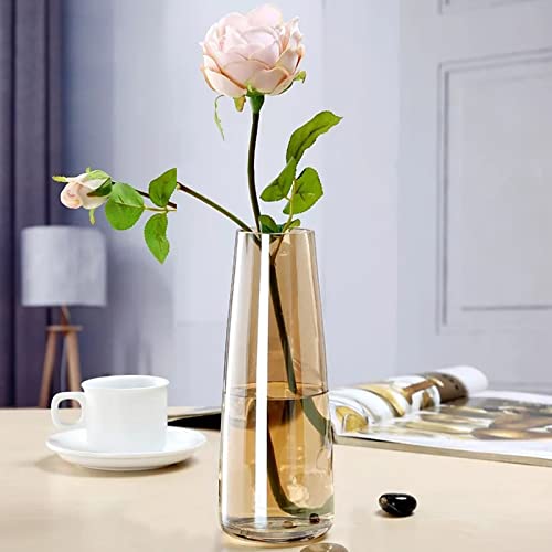 A vase holding a single red rose on a table.