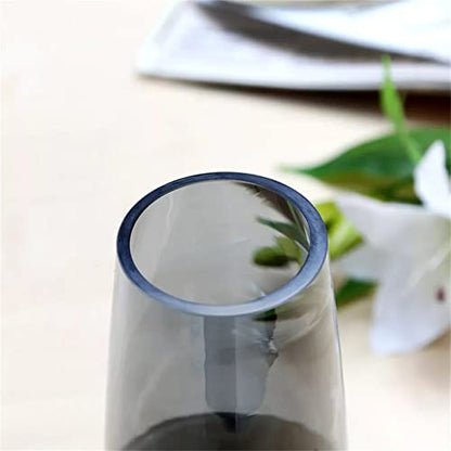  A clear glass vase holding a delicate flower.