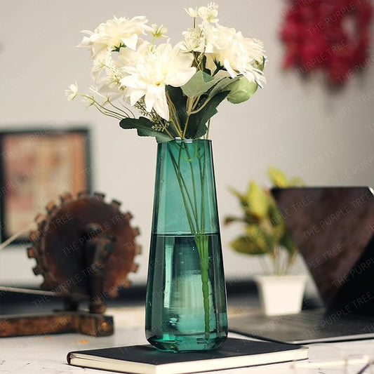 Bright flowers in a vase on a desk.
