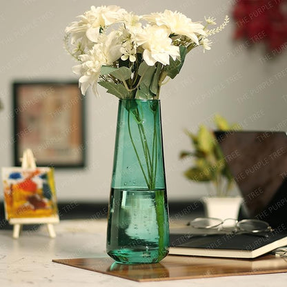Flowers arranged in a green vase on a table