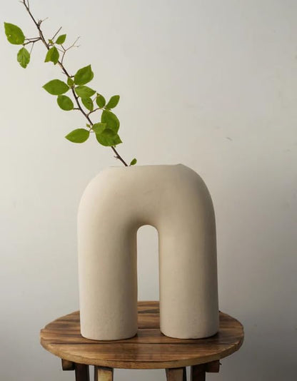 Leafy plant in a white vase.