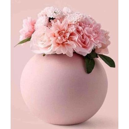 A lovely pink vase filled with delicate pink flowers, adding a touch of elegance.