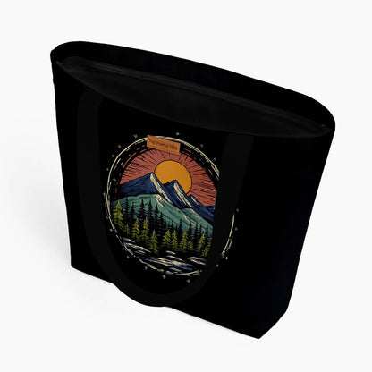 A black tote bag showcasing a picturesque mountain view.