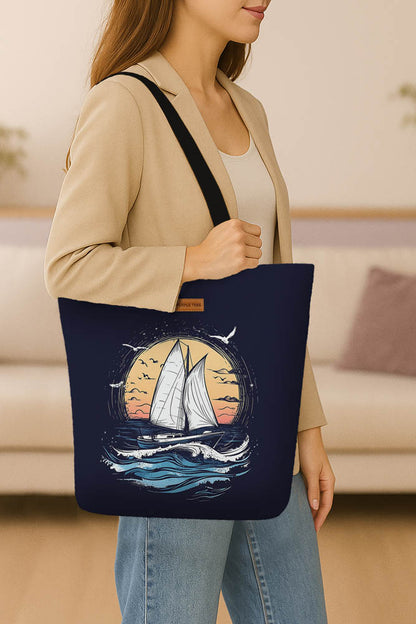 A tote bag adorned with an illustration of a sailboat sailing on the ocean, capturing a peaceful nautical theme.