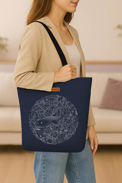 A blue tote bag adorned with a colorful illustration of a whale, showcasing marine life art.