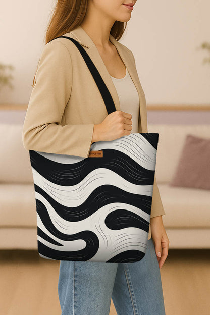 Stylish black and white zebra print tote bag, featuring a spacious interior and durable design for everyday use.