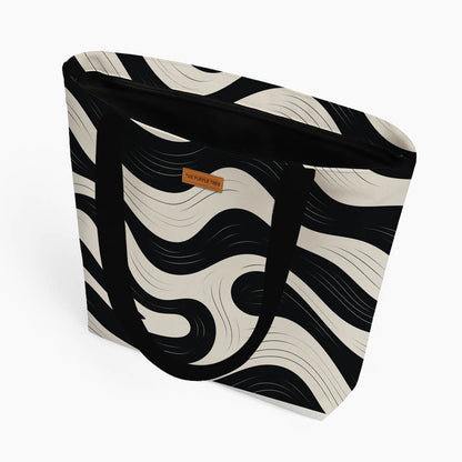 Elegant black and white zebra print tote bag, perfect for carrying essentials while adding a trendy touch to any outfit.
