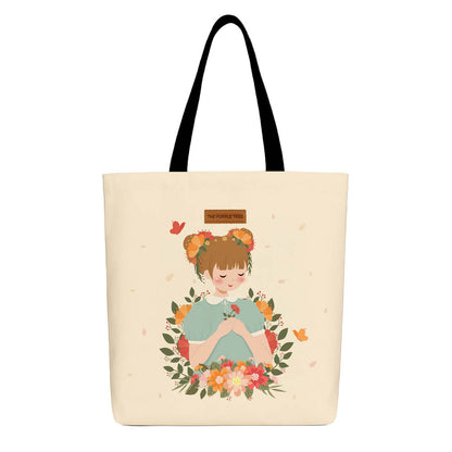 A tote bag featuring a girl holding flowers surrounded by colorful butterflies.