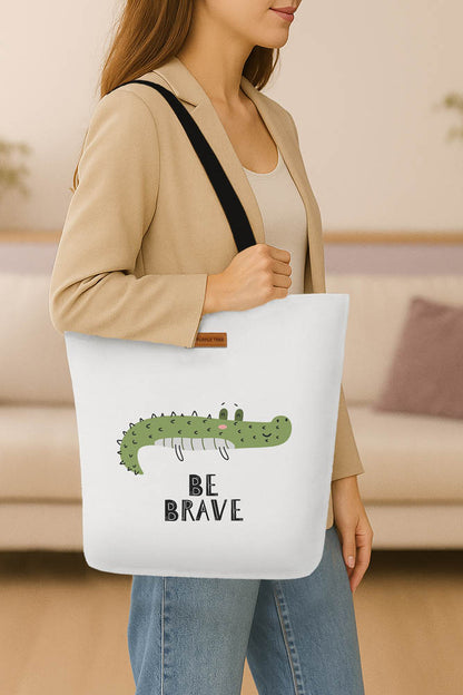 A tote bag adorned with a courageous crocodile illustration, perfect for carrying essentials with style.