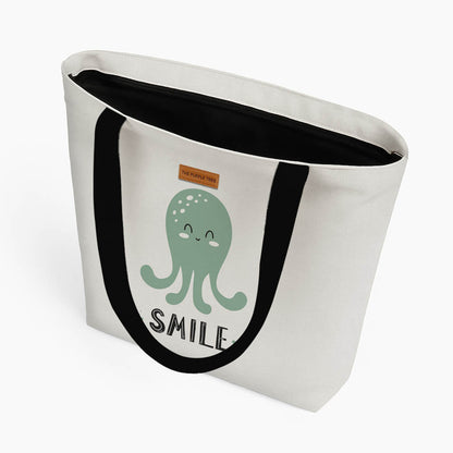 A tote bag displaying an octopus design alongside the phrase "Smile" in a playful font.