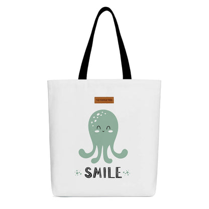 A tote bag featuring a smiling octopus with the text "Smile" printed above it.