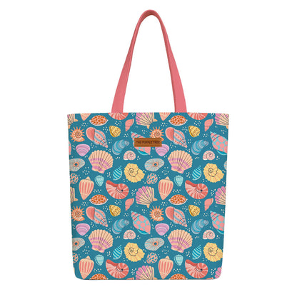 A blue tote bag adorned with vibrant, colorful shell patterns.

