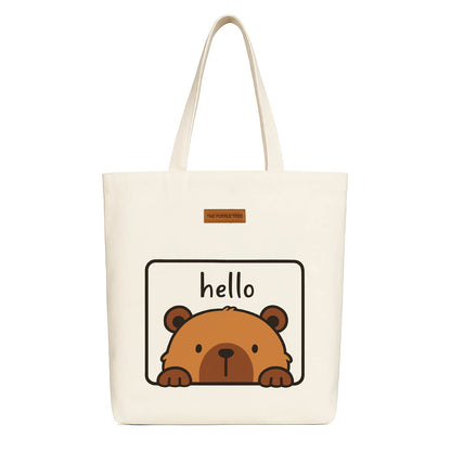 A tote bag featuring a friendly bear design with the word "hello" prominently displayed.